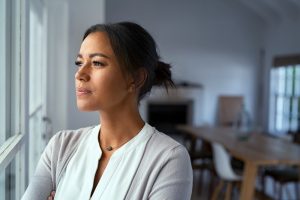 worried woman looking out of window