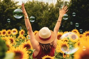woman facing sun arms open