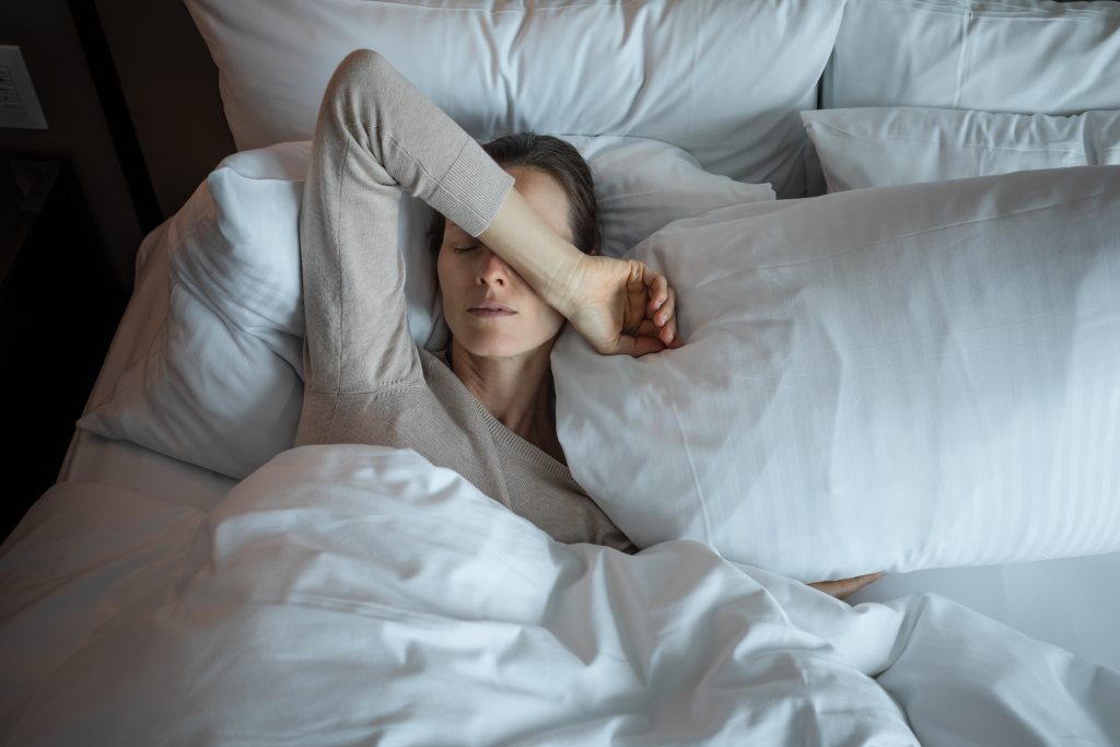 Young woman waking up in the morning feeling